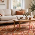 A living room with a large area rug under the sofa and coffee table, sized to fit the seating area