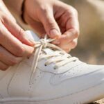 A person tying shoelaces, showing the correct spelling tying